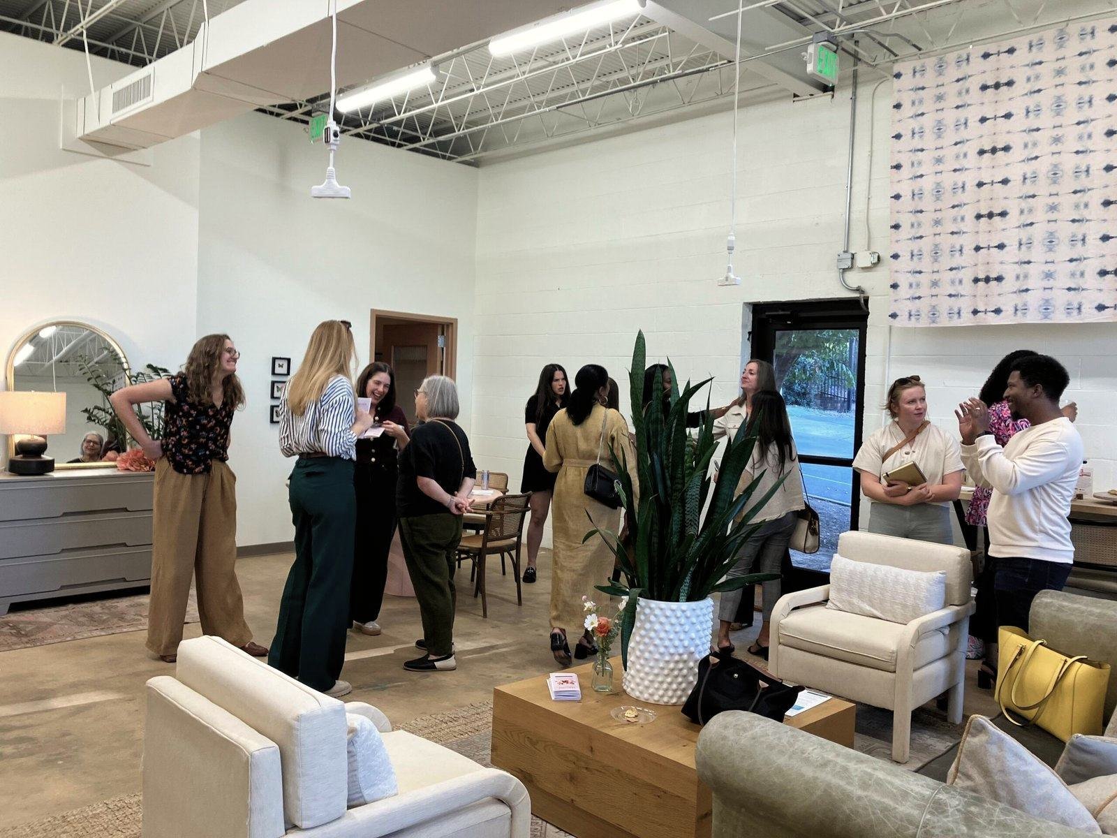 Women talking together in a room at a Malone Unlimited gathering