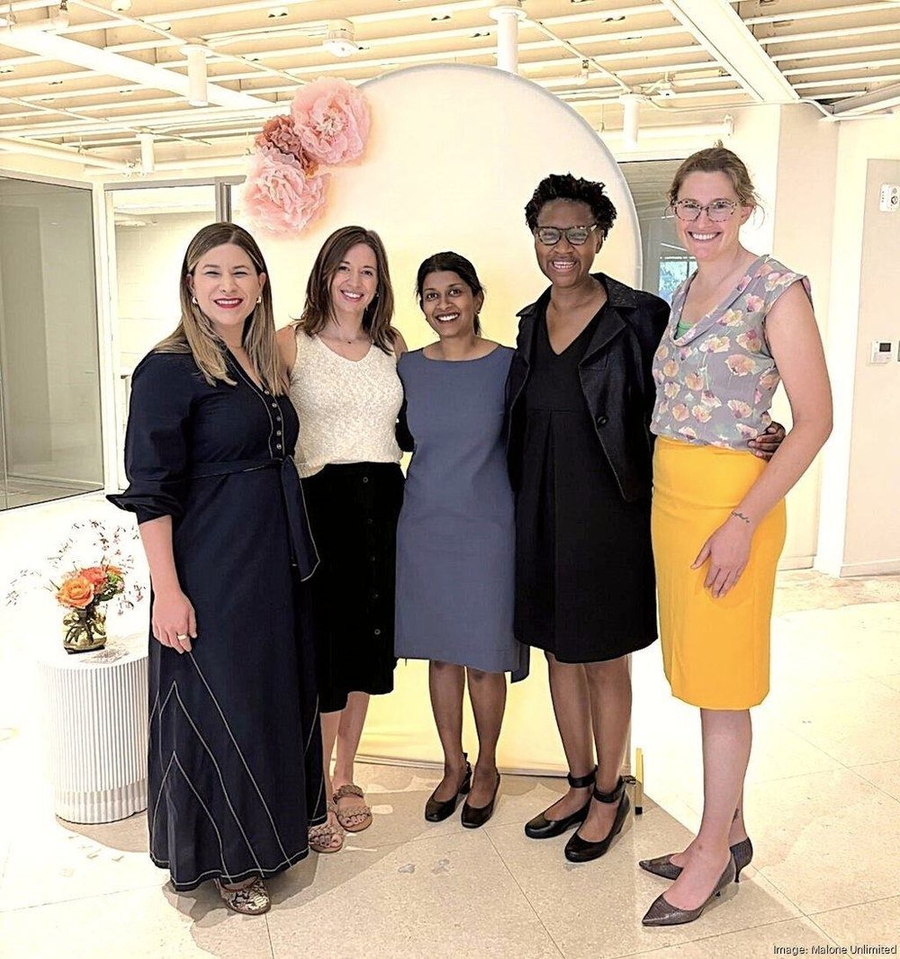 Five women standing together for a photograph