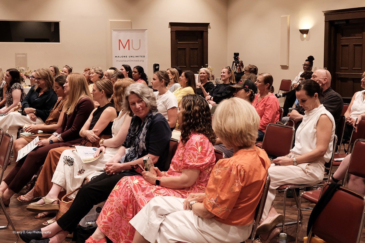 A full room listening at a Malone Unlimited event